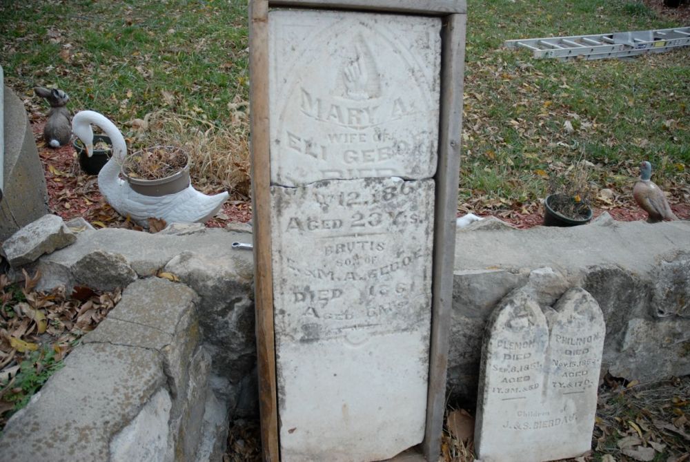 Headstones from the Miamitown cemetery.  On the left is the stone for Mary A. Geboe (the wife of Eli Geboe) and her son Brutus.  The stone on the right is believed to be from one of the early non-Myaamia settler families, but as of publication this has not been confirmed.